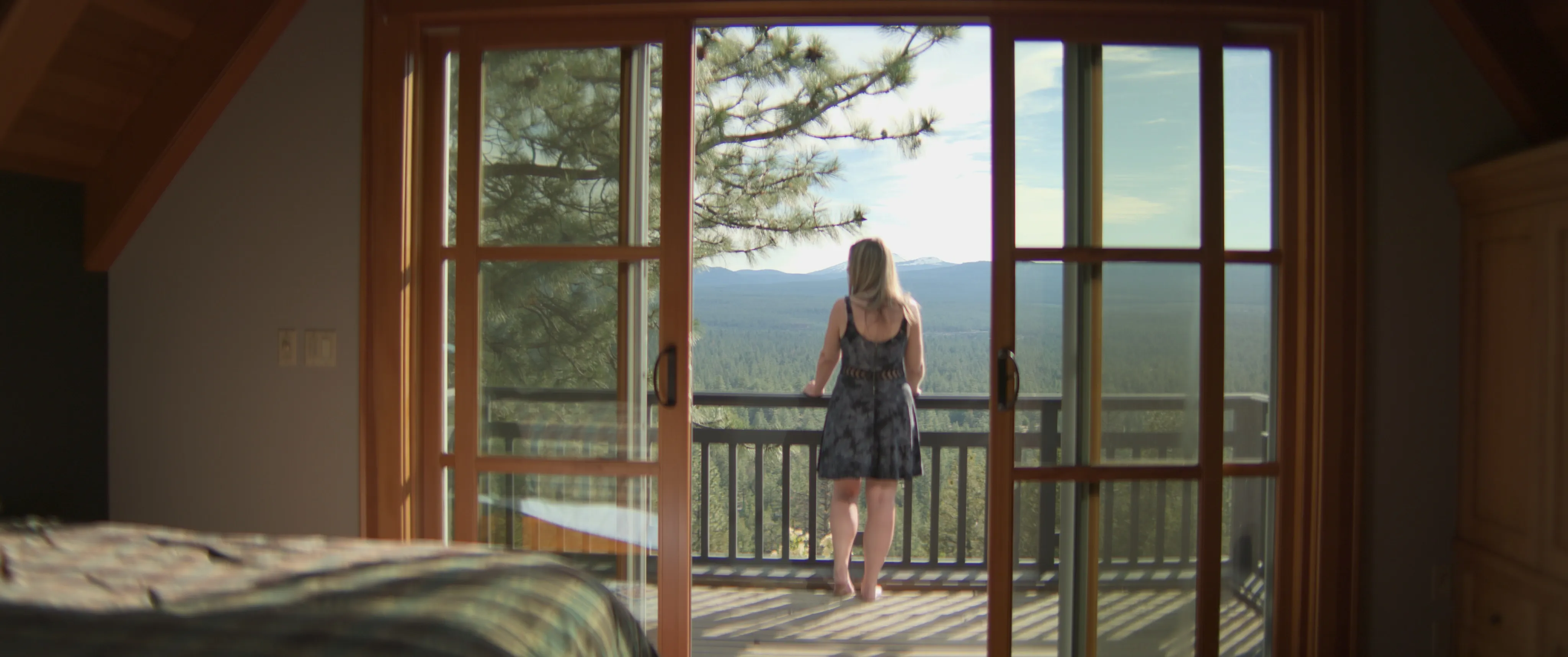 A guest resting on a rock ledge above a river valley